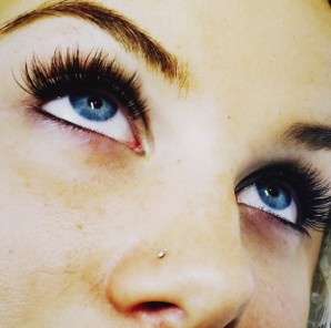 Blue eyes framed by long, dark lash extensions