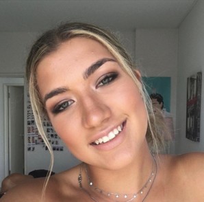 Smiling client showing her lash extensions