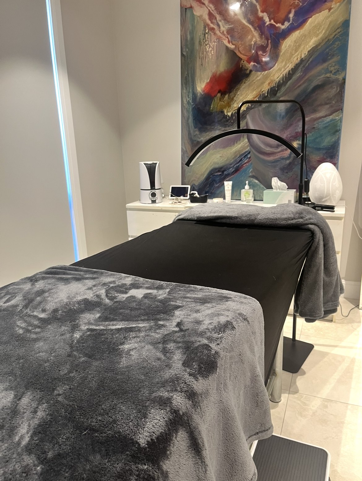 The Angel Lash treatment room, with a lash bed, lamp and artwork